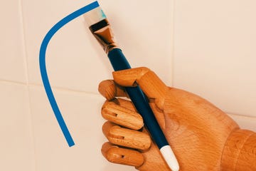 robot hand holding a paint brush