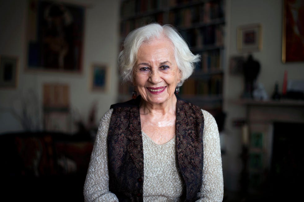 an elderly woman poses for a portrait