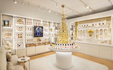 dior store display with a christmas tree and fragrance products