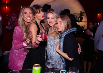 group of women at an event holding drinks and interacting