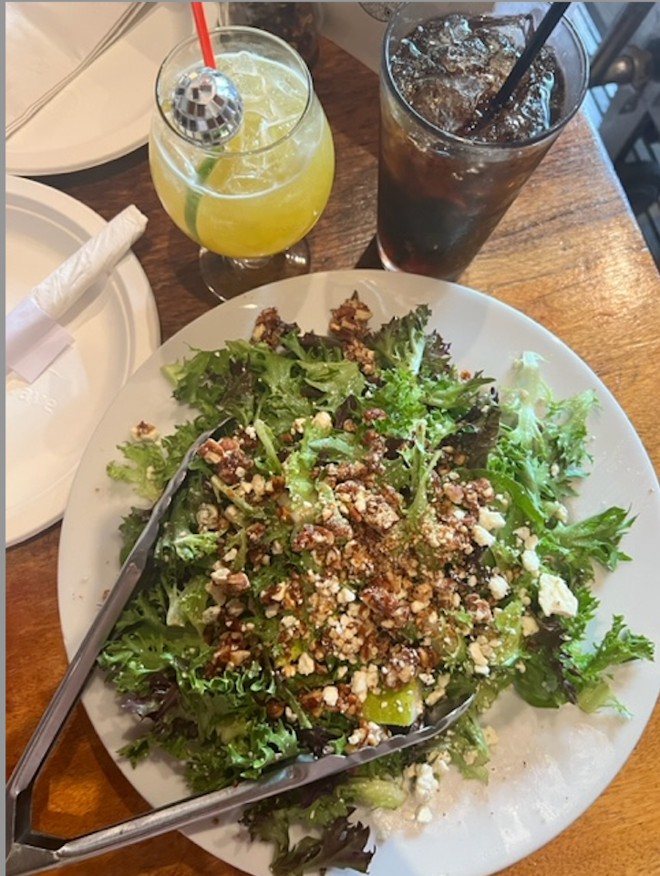 a plate of food and a glass of juice