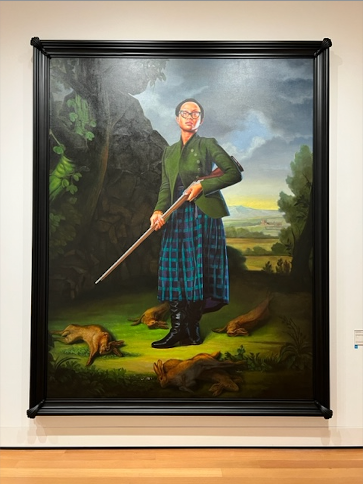 a framed painting of a man holding a sword