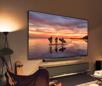 wallmounted tv displaying surfers at sunset