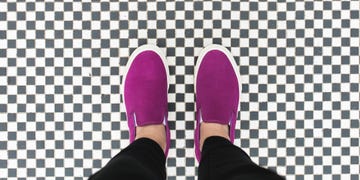 magenta slip on sneakers on checkerboard tile floor