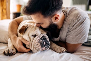 man hugging dog