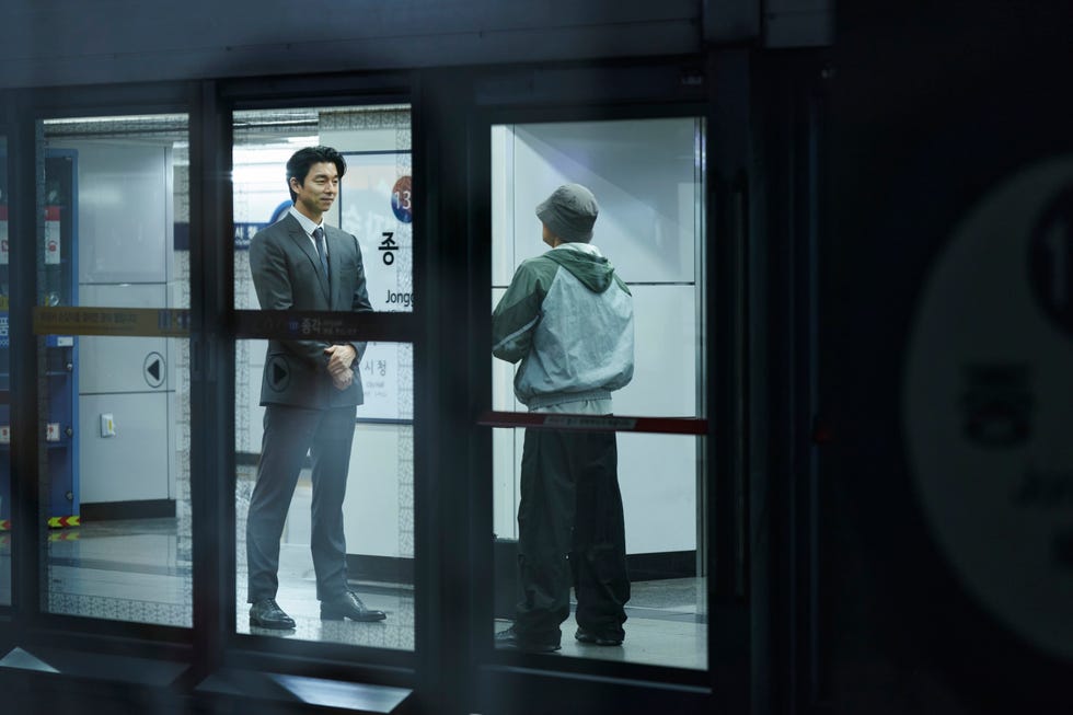 two individuals interacting in a subway station