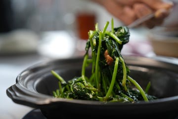 stir fried sweet potato leaves in clay pot with pork lard