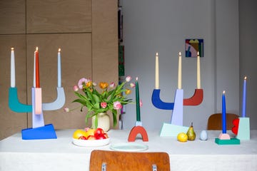 decorative table setting with colorful candle holders flowers and fruit