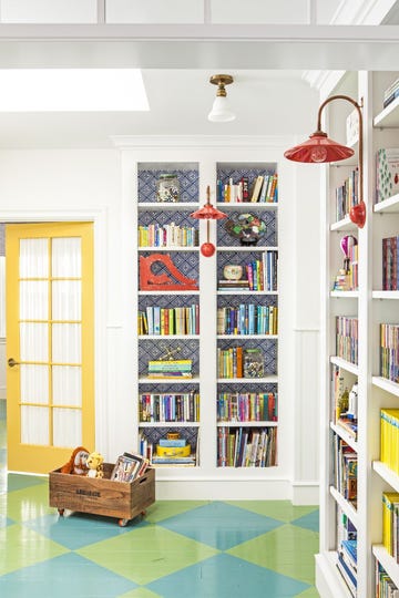 wheeled crate stuffed animal storage idea holding toy giraffe and ape in room with bookshelves