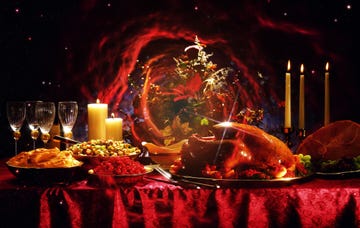 a festive dinner table with a beautifully cooked turkey and various side dishes