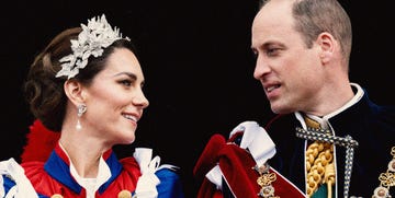 the prince and princess of wales in full royal regalia look at one another and smile