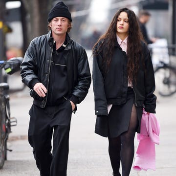 a man and woman walking down a sidewalk