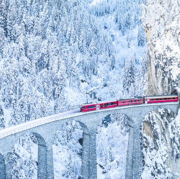 train entering in a tunnel on snowy mountains