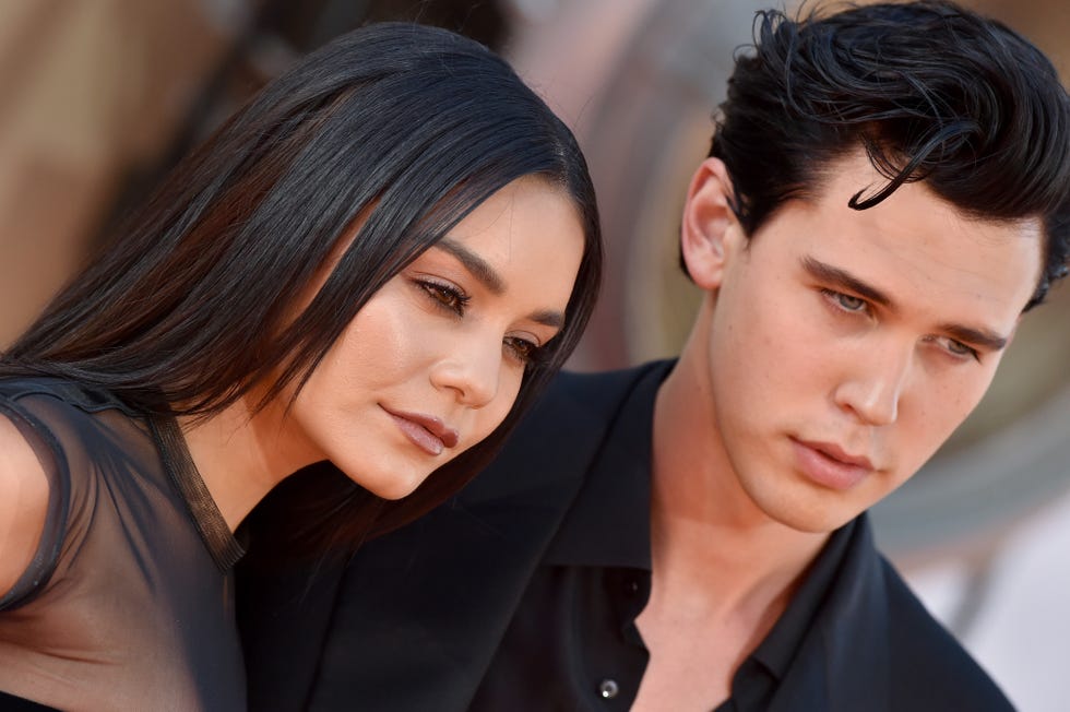 a close up of vanessa hudgens and austin butler looking off camera at a movie premiere, with both wearing black