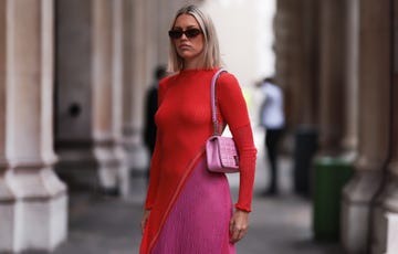 a woman wearing a pink dress and sunglasses