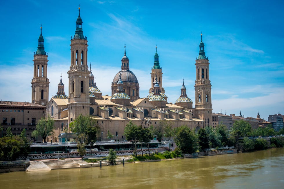 a view of the basilica cathedral of our lady of the pillar next to the ebro river