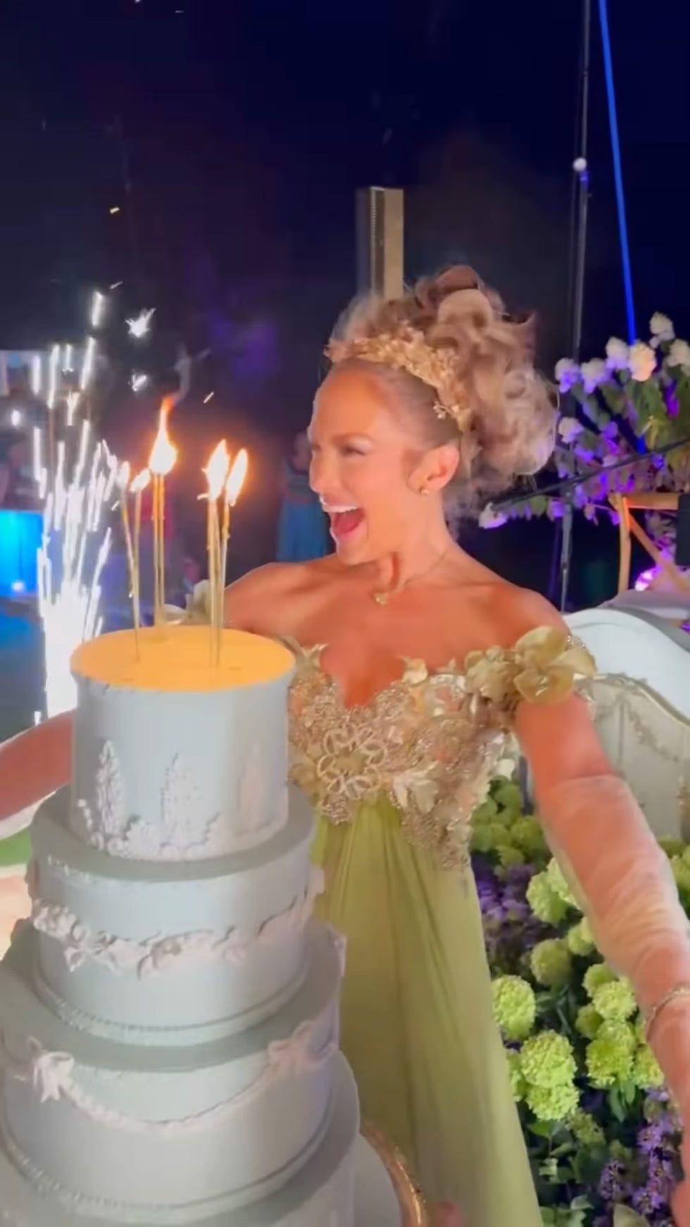 a woman in a dress with a cake with candles