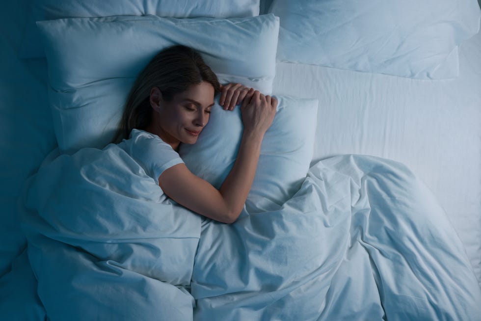 woman sleeping in bed at night, above view space for text