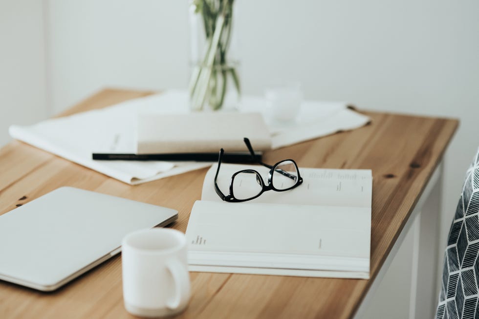 workspace table with smartphone, eyeglasses, schedule calendar and coffee