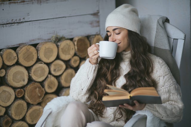 young beautiful woman drinking tea christmas decorations,united states,usa