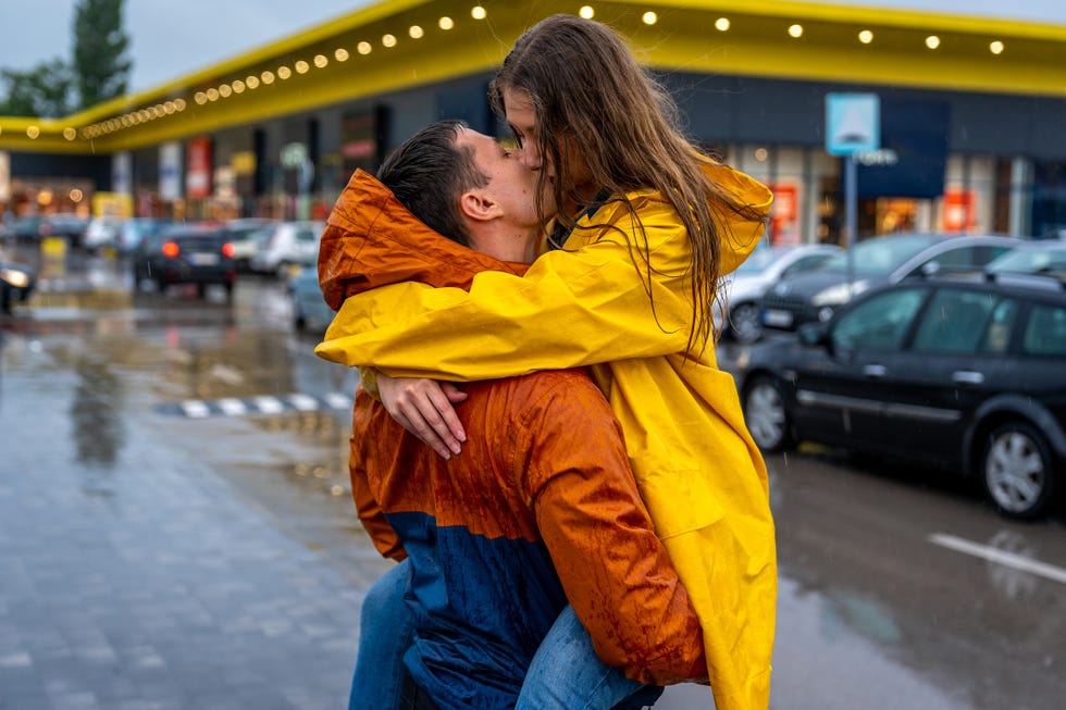 young couple kissing on the rain