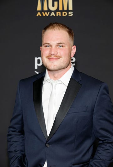 zach bryan stops for a photo at the academy of country music awards