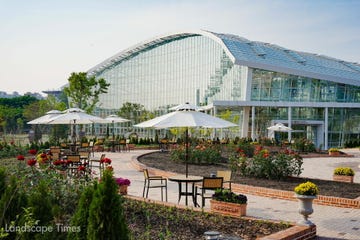 a large greenhouse with tables and chairs