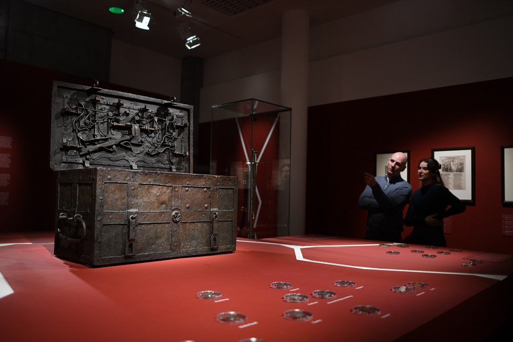 Two visitors looking at war chest