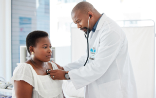 A doctor listens to the heartbeat of a severe COVID-19 infection survivor