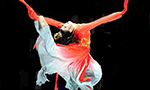 Dancer dressed in red, expressing emotion and movement in her performance