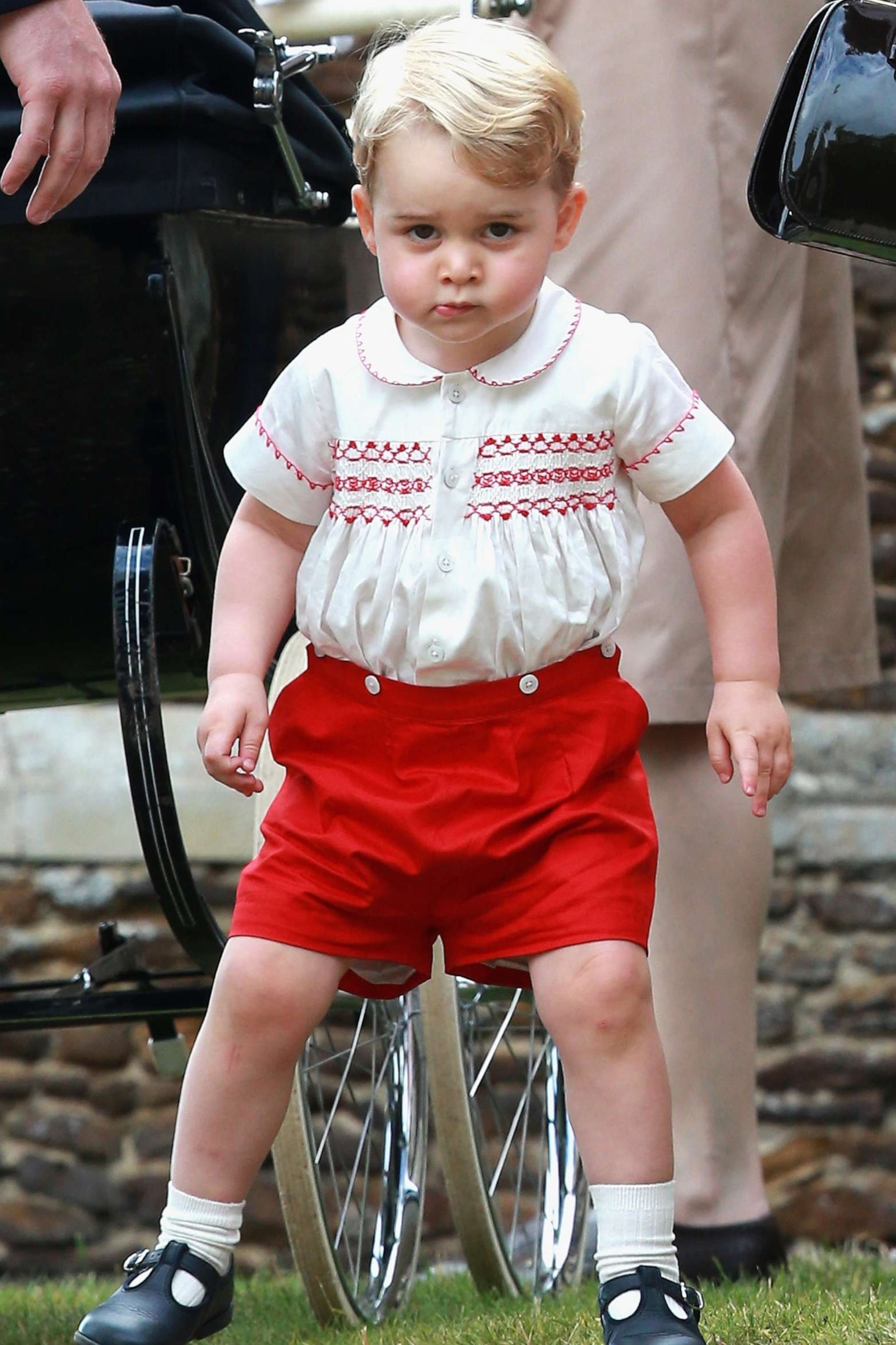 PHOTO: Prince George of Cambridge leaves the Church of St Mary Magdalene on the Sandringham Estate for the Christening of Princess Charlotte of Cambridge on July 5, 2015, in King's Lynn, England.