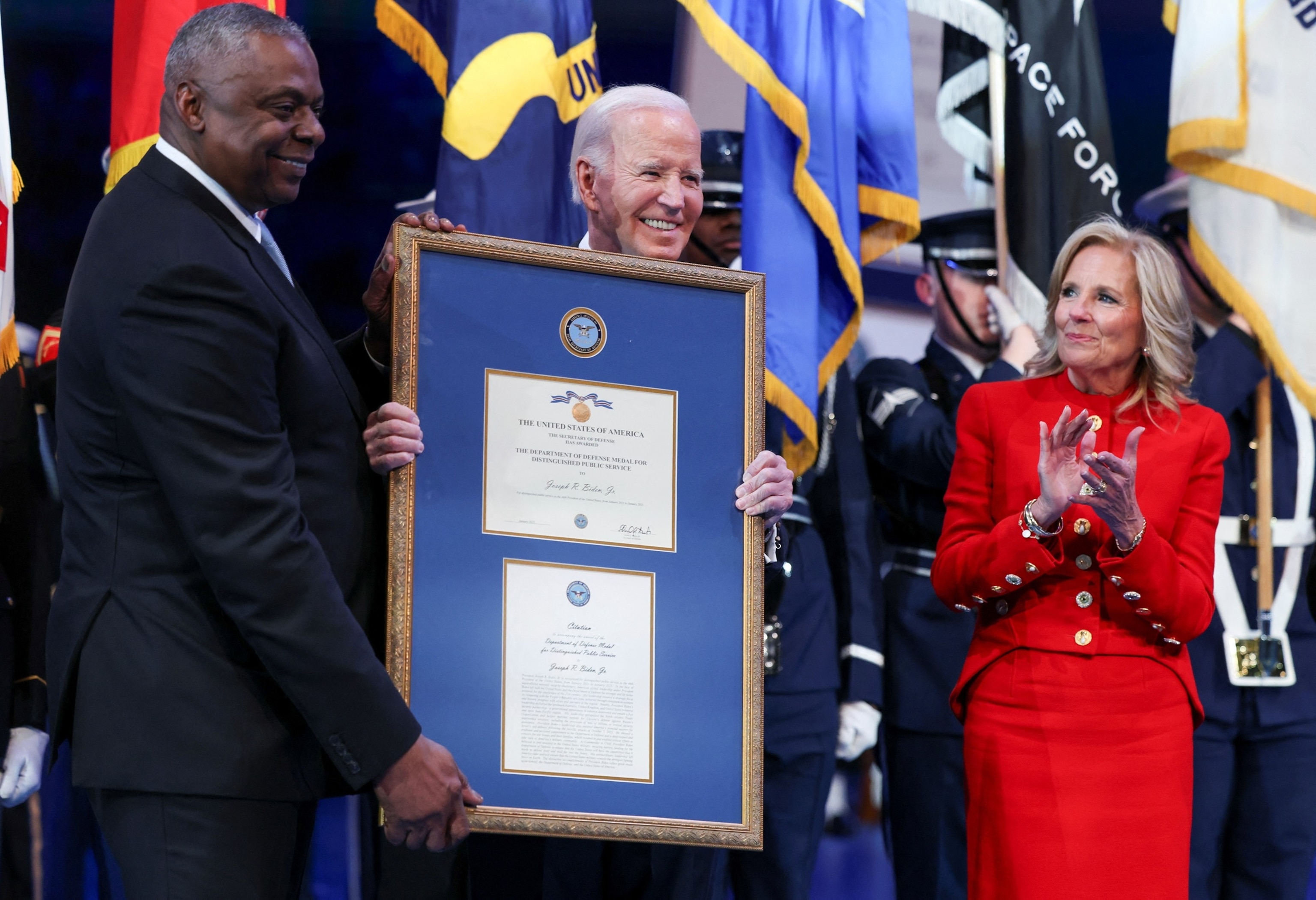 PHOTO: President Biden, flanked by Defense Secretary Austin and first lady Biden, receives a Department of Defense medal for Distinguished Public Service during a Department of Defense Commander in Chief farewell ceremony in Fort Myer, Va., Jan. 16, 2025.