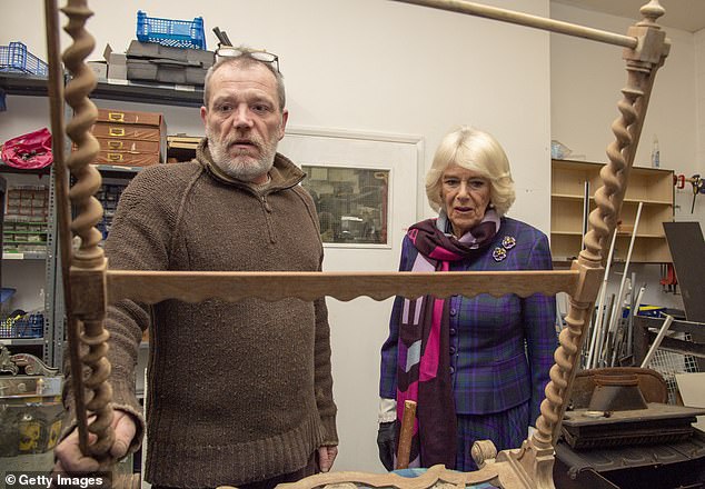 The Duchess of Cornwall meets Adam White in the woodwork room as she visits Emmaus Greenwich in celebration of their 25th anniversary