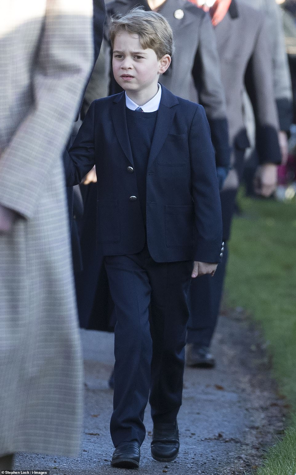 Six-year-old Prince George, who is usually clad in shorts, cut a very smart figure in a suit and tie