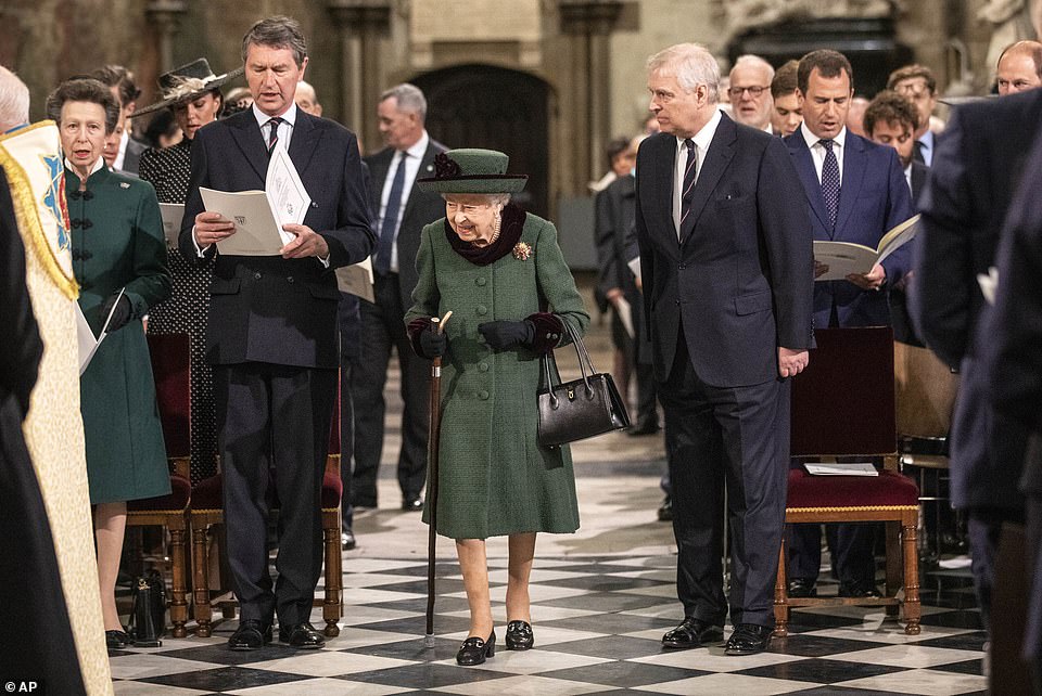 The Queen walks towards her seat at Westminster Abbey after being accompanied by Prince Andrew yesterday