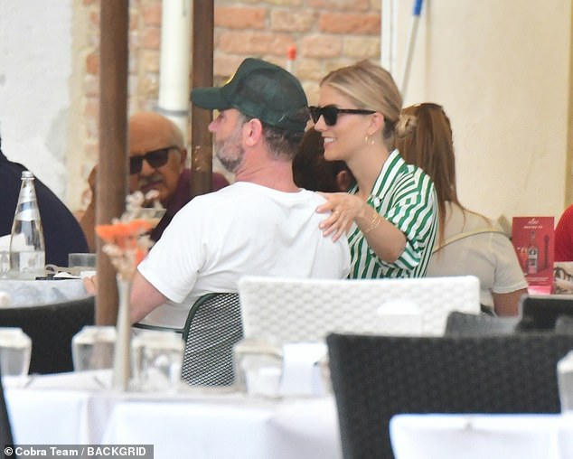 Adorable: Taylor gently placed her hand on Liev's shoulder during the meal