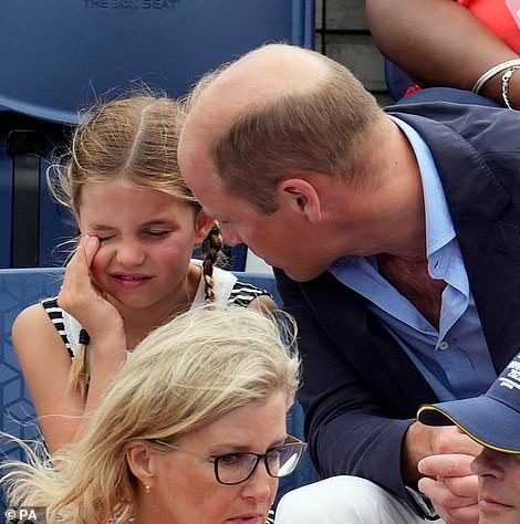 A cuddle from Dad! Prince William took his younger daughter under his arm after he spotted she was rubbing her eyes during the match