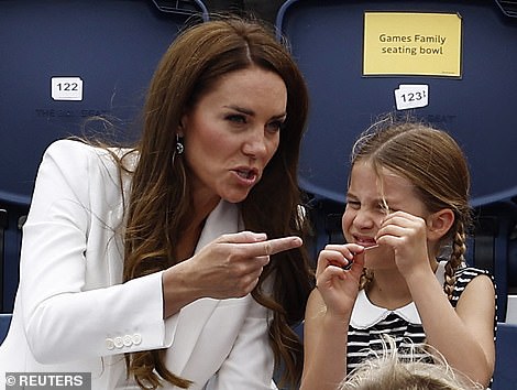 Charlotte appeared preoccupied with her hair as Kate seemed to gesture at the ongoing hockey match while the young family enjoyed the Games