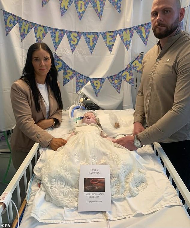 Claire Staniforth and Dean Gregory with Indi Gregory in September after she was baptised