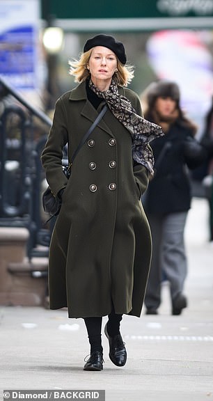 The costume department complimented the color theme by dressing her in black gloves, beret and shoes