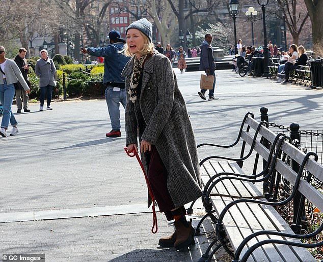 To keep warm, she sported a blue knitted beanie and a patterned scarf around her neck