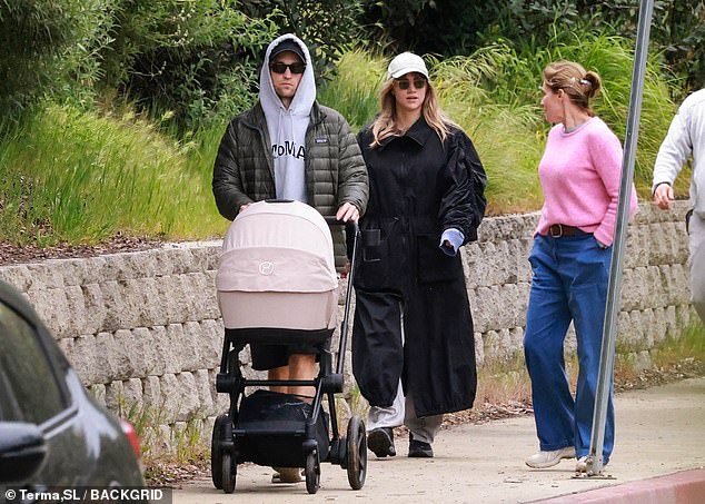 The couple were joined by Suki's mother Elizabeth on the walk who wore a bright pink jumper and jeans