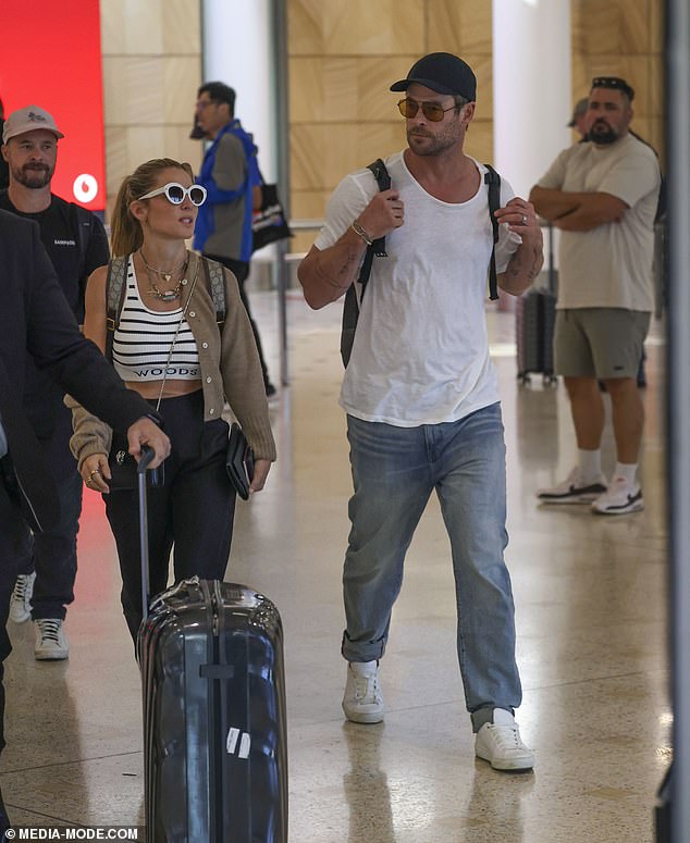 Chris meanwhile showcased his muscle-bound physique in a thin white T-shirt and jeans, paired with white sneakers, a black baseball cap and a pair of brown-tint aviator sunglasses