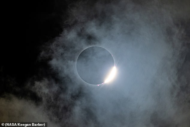 The NASA photo researcher took multiple high resolution snaps of these solar prominences, unusually visible thanks to the moon, which had eclipsed everything but the sun's white corona and its reddish-pink chromosphere