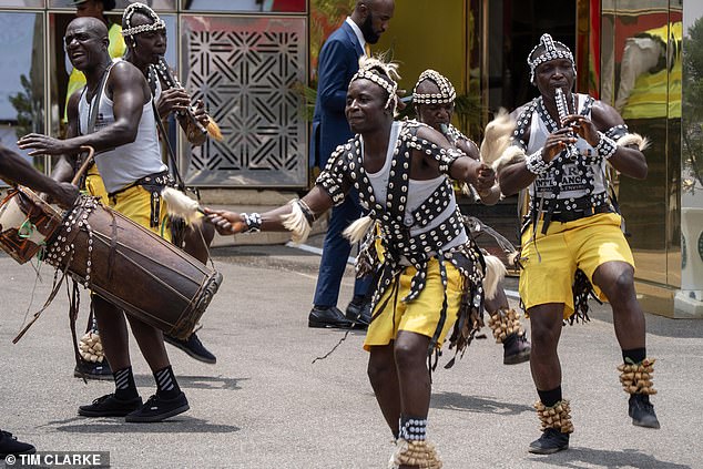 Dancers outside Nigeria's Defence Headquarters in Abuja to welcome the Sussexes today