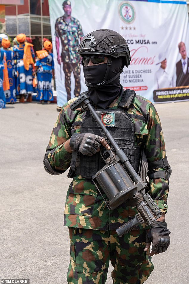 A soldier outside Nigeria's Defence Headquarters in Abuja as the Sussexes arrive today