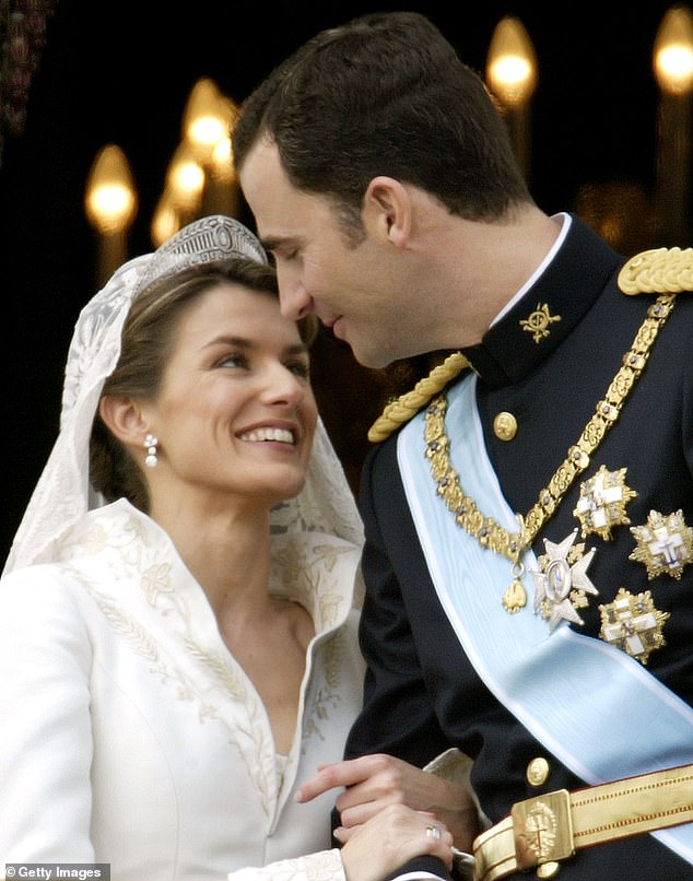 Spanish Crown Prince Felipe de Bourbon and his bride Letizia look at each other as the royal couple appears on the balcony of Royal Palace May 22, 2004