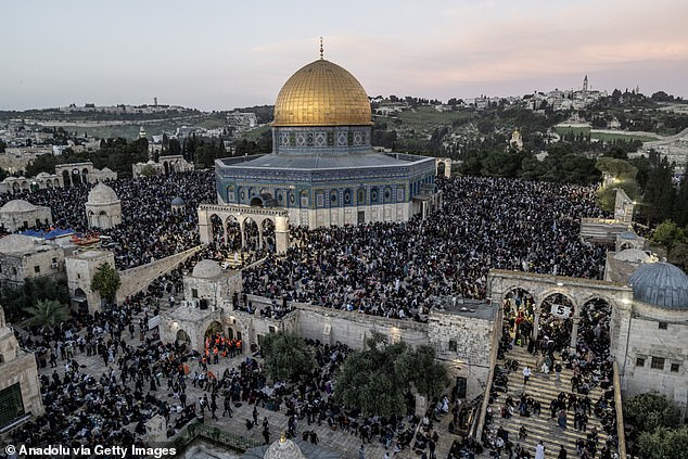 An aerial view of thousands of Palestinian worshipers gather to break their fast on the last Friday prayer of the holy month of Ramadan and perform prayer on the night of Laylat al-Qadr at Al-Aqsa Mosque in East Jerusalem, on April 5, 2024