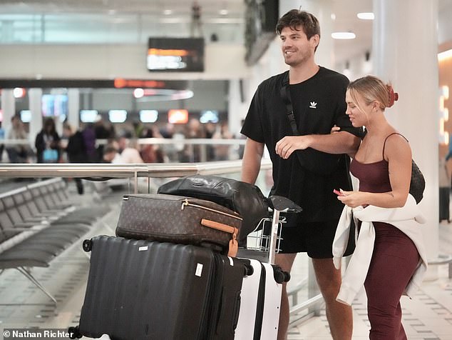 The 28-year-old wheeled along the pair's luggage which included a Louis Vuitton bag and a stack of suitcases