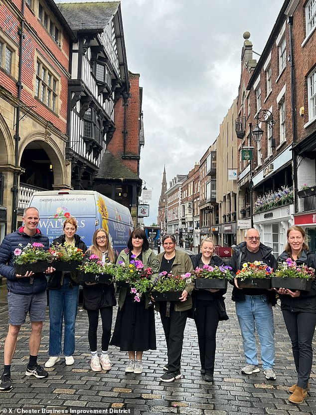 Snaps from today pictured volunteers holding onto the blossoms and distributing them around the streets